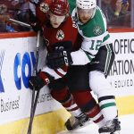 Arizona Coyotes center Christian Dvorak (18) battles with Dallas Stars center Radek Faksa (12) for the puck during the first period of an NHL hockey game Thursday, Oct. 19, 2017, in Glendale, Ariz. (AP Photo/Ross D. Franklin)