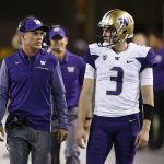 Washington coach Chris Peterson, left, talks with quarterback Jake Browning (3) during the first half of an NCAA college football game against Arizona State on Saturday, Oct. 14, 2017, in Tempe, Ariz. (AP Photo/Ross D. Franklin)