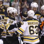 Boston Bruins' David Pastrnak (88) celebrates with teammates Riley Nash (20), Brad Marchand (63), Zdeno Chara (33) and Brandon Carlo (25) after his first period goal against the Arizona Coyotes during an NHL hockey game, Saturday, Oct. 14, 2017, in Glendale, Ariz. (AP Photo/Ralph Freso)