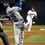 Los Angeles Dodgers' Cody Bellinger (35) connects for an RBI ground out as Arizona Diamondbacks starting pitcher Zack Greinke follows through during the first inning of game 3 of baseball's National League Division Series, Monday, Oct. 9, 2017, in Phoenix. (AP Photo/Rick Scuteri)