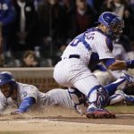 Los Angeles Dodgers' Chris Taylor slides safely into home plate against Chicago Cubs catcher Willson Contreras during the first inning of Game 5 of baseball's National League Championship Series, Thursday, Oct. 19, 2017, in Chicago. (AP Photo/Matt Slocum)