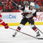 Arizona Coyotes left wing Brendan Perlini, of Britain, (11) shoots on Detroit Red Wings defenseman Xavier Ouellet, of France, (61) in the first period of an NHL hockey game Tuesday, Oct. 31, 2017, in Detroit. (AP Photo/Paul Sancya)