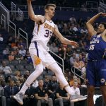 Phoenix Suns forward Dragan Bender (35) looks to pass the ball past Brisbane Bullets forward Grant Jerrett during the second half of an NBA basketball exhibition game Friday, Oct. 13, 2017, in Phoenix. (AP Photo/Ralph Freso)