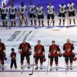 Members of the Arizona Coyotes, foreground, and the Vegas Golden Knights pause for a moment of silence for shooting victims in Las Vegas before an NHL hockey game Saturday, Oct. 7, 2017, in Glendale, Ariz. (AP Photo/Ross D. Franklin)