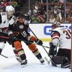 Anaheim Ducks right wing Corey Perry, center, attempts a shot for a goal on Arizona Coyotes goalie Louis Domingue, right, while defended by defenseman Oliver Ekman-Larsson during the second period of an NHL hockey game in Anaheim, Calif., Thursday, Oct. 5, 2017. (AP Photo/Kelvin Kuo)