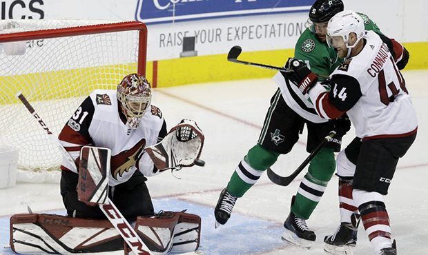 Arizona Coyotes goalie Adin Hill (31) and defenseman Kevin Connauton (44) defend the goal against D...