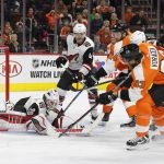 Arizona Coyotes' Scott Wedgewood, left, covers up the puck as Philadelphia Flyers' Sean Couturier, center, and Jakub Voracek, of the Czech Republic, right, reach in for the it during the second period of an NHL hockey game, Monday, Oct. 30, 2017, in Philadelphia. (AP Photo/Chris Szagola)