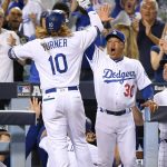 Los Angeles Dodgers' Justin Turner, left, celebrates his three-run home run with manager Dave Roberts at the dugout during the first inning of Game 1 of the baseball team's National League Division Series against the Arizona Diamondbacks in Los Angeles, Friday, Oct. 6, 2017. (AP Photo/Mark J. Terrill)