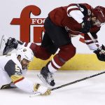 Arizona Coyotes right wing Tobias Rieder (8) gets tripped up by Vegas Golden Knights defenseman Deryk Engelland (5) during the third period of an NHL hockey game Saturday, Oct. 7, 2017, in Glendale, Ariz. The Golden Knights defeated the Coyotes 2-1 in overtime. (AP Photo/Ross D. Franklin)