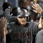 Arizona Diamondbacks' Brandon Drury celebrates in the dugout his three-run home run off Los Angeles Dodgers relief pitcher Brandon Morrow during the seventh inning of Game 2 of baseball's National League Division Series in Los Angeles, Saturday, Oct. 7, 2017. (AP Photo/Mark J. Terrill)