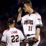 Arizona Diamondbacks starting pitcher Zack Greinke (21) adjusts his cap after giving up a base hit during the third inning of game 3 of baseball's National League Division Series against the Los Angeles Dodgers, Monday, Oct. 9, 2017, in Phoenix. (AP Photo/Ross D. Franklin)