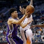 Sacramento Kings forward Justin Jackson, left, passes around Phoenix Suns forward Marquese Chriss during the first half of an NBA basketball game, Monday, Oct. 23, 2017, in Phoenix. (AP Photo/Matt York)
