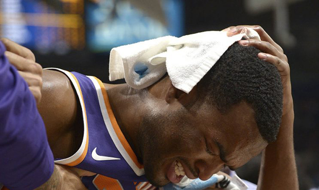 Phoenix Suns forward T.J. Warren (12) leaves the game holding the back of his head in the first hal...
