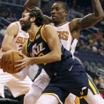 Utah Jazz guard Ricky Rubio, left, drives to the basket as he is guarded by Phoenix Suns' Erik Bledsoe during the first half of a preseason NBA basketball game, Monday, Oct. 9, 2017, in Phoenix. (AP Photo/Ralph Freso)