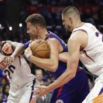 Los Angeles Clippers' Blake Griffin, center, is pressured by Phoenix Suns' Josh Jackson, left, and Alex Len during the second half of an NBA basketball game Saturday, Oct. 21, 2017, in Los Angeles. The Clippers won 130-88. (AP Photo/Jae C. Hong)