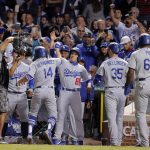Los Angeles Dodgers' Enrique Hernandez (14) is greeted by his teammates after a grand slam in the third inning against the Chicago Cubs in Game 5 of the National League Championship Series, Thursday, Oct. 19, 2017, at Wrigley Field in Chicago. (Steve Lundy/Daily Herald via AP)