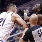 Official Aaron Smith (51) tries to separate Phoenix Suns center Alex Len (21) and Portland Trail Blazers forward Caleb Swanigan after the two got into a shoving match during the second half of an NBA preseason basketball game Wednesday, Oct. 11, 2017, in Phoenix. Both players were ejected for fighting. (AP Photo/Darryl Webb)