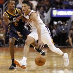 Phoenix Suns guard Devin Booker (1) drives past Utah Jazz guard Rodney Hood (5) during the second half of an NBA basketball game, Wednesday, Oct. 25, 2017, in Phoenix. The Suns won 97-88. (AP Photo/Matt York)