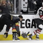 Vegas Golden Knights defenseman Luca Sbisa loses his helmut after he was checked by Arizona Coyotes center Nick Cousins during the second period of an NHL hockey game Tuesday, Oct. 10, 2017, in Las Vegas. (AP Photo/John Locher)