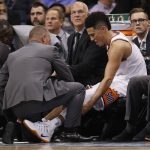 Phoenix Suns guard Devin Booker is helped on the bench after coming out of the NBA basketball game against the Portland Trail Blazers with an apparent injury, Wednesday, Oct. 18, 2017, in Phoenix. (AP Photo/Matt York)