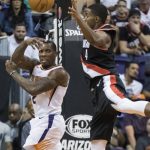 Phoenix Suns guard Eric Bledsoe passes the ball as Portland Trail Blazers guard Maurice Harkless (4) closes in during the second half of an NBA preseason basketball game Wednesday, Oct. 11, 2017, in Phoenix. (AP Photo/Darryl Webb)