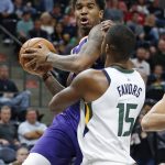 Phoenix Suns forward Marquese Chriss, left, goes to the basket as Utah Jazz forward Derrick Favors (15) defends during the first half of a preseason NBA basketball game Friday, Oct. 6, 2017, in Salt Lake City. (AP Photo/Rick Bowmer)