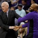 Phoenix Suns head coach Jay Triano greets Sacramento Kings guard Vince Carter prior an NBA basketball game, Monday, Oct. 23, 2017, in Phoenix. It was Triano's first game as the Suns' head coach. (AP Photo/Matt York)