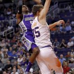 Sacramento Kings guard De'Aaron Fox shoots over Phoenix Suns forward Dragan Bender (35) during the first half of an NBA basketball game, Monday, Oct. 23, 2017, in Phoenix. (AP Photo/Matt York)