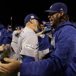 Los Angeles Dodgers' Enrique Hernandez and Clayton Kershaw celebrate after Game 5 of baseball's National League Championship Series against the Chicago Cubs, Thursday, Oct. 19, 2017, in Chicago. The Dodgers won 11-1 to win the series and advance to the World Series. (AP Photo/Matt Slocum)