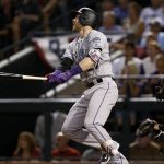 Colorado Rockies' Trevor Story watches his solo home run against the Arizona Diamondbacks during the eighth inning of the National League wild-card playoff baseball game, Wednesday, Oct. 4, 2017, in Phoenix. (AP Photo/Ross D. Franklin)