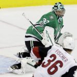 Dallas Stars goalie Ben Bishop (30) deflects a shot as Arizona Coyotes right wing Christian Fischer (36) looks on during the second period of an NHL hockey game in Dallas, Tuesday, Oct. 17, 2017. (AP Photo/LM Otero)