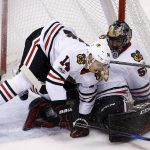 Chicago Blackhawks' Richard Panik (14) collides with goalie Corey Crawford, right, during the first period of an NHL hockey game against the Arizona Coyotes Saturday, Oct. 21, 2017, in Glendale, Ariz. (AP Photo/Ross D. Franklin)