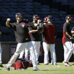 Arizona Diamondbacks third baseman Jake Lamb, second from left, warms up with teammates during practice at Chase Field as the team gets ready for a National League wild-card playoff baseball game Monday, Oct. 2, 2017, in Phoenix. The Diamondbacks face the Colorado Rockies on Wednesday. (AP Photo/Ross D. Franklin)