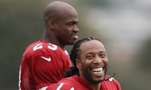 Wide receiver Larry Fitzgerald, right, and running back Adrian Peterson of the Arizona Cardinals la...