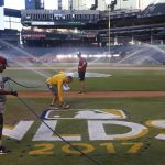Members of the grounds crew prepare the field at Chase Field for Game 3 of baseball's National League Division Series between the Arizona Diamondbacks and the Los Angeles Dodgers Sunday, Oct. 8, 2017, in Phoenix. (AP Photo/Ross D. Franklin)