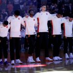 Phoenix Suns embrace during the national anthem prior to an NBA basketball game against the Portland Trail Blazers, Wednesday, Oct. 18, 2017, in Phoenix. (AP Photo/Matt York)