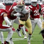 San Francisco 49ers running back Carlos Hyde (28) is hit by Arizona Cardinals nose tackle Corey Peters during the second half of an NFL football game, Sunday, Oct. 1, 2017, in Glendale, Ariz. (AP Photo/Rick Scuteri)