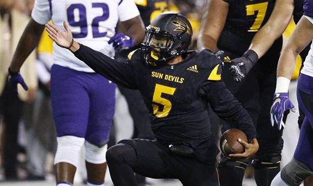 Arizona State quarterback Manny Wilkins (5) signals a first down against Washington during the firs...