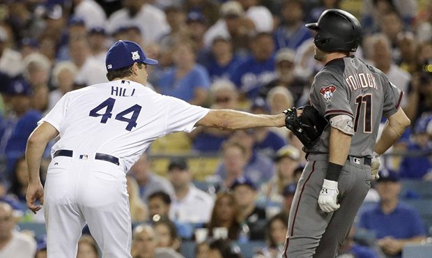 Los Angeles Dodgers starting pitcher Rich Hill, left, tags out Arizona Diamondbacks' A.J. Pollock d...