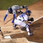 Los Angeles Dodgers' Chris Taylor slides safely into home plate against Chicago Cubs catcher Willson Contreras during the first inning of Game 5 of baseball's National League Championship Series, Thursday, Oct. 19, 2017, in Chicago. (Johns Starks/Daily Herald via AP)