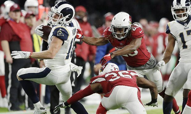 Los Angeles Rams quarterback Jared Goff (16) is tackled by Arizona Cardinals safety Budda Baker (36...
