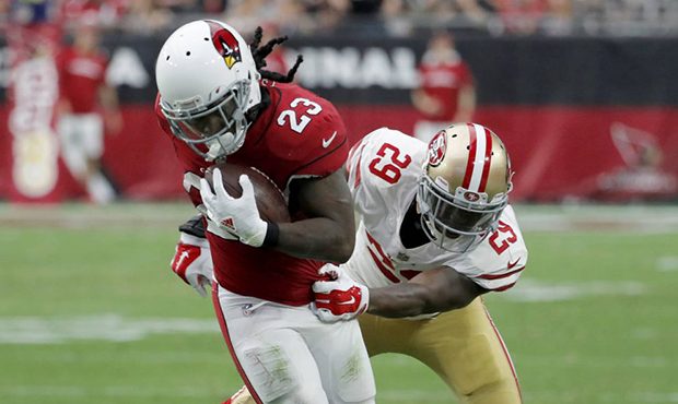Arizona Cardinals running back Chris Johnson (23) is hit by San Francisco 49ers free safety Jaquisk...