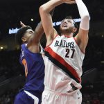 Phoenix Suns forward Marquese Chriss blocks the shot of Portland Trail Blazers center Jusuf Nurkic during the first half of an NBA basketball preseason game in Portland, Ore., Tuesday, Oct. 3, 2017. (AP Photo/Steve Dykes)