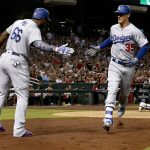 Los Angeles Dodgers Cody Bellinger (35) greets Yasiel Puig (66) after hitting a solo home run during the fifth inning of game 3 of baseball's National League Division Series, Monday, Oct. 9, 2017, in Phoenix. (AP Photo/Ross D. Franklin)