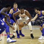 Phoenix Suns' TJ Warren, center, is defended by Los Angeles Clippers' Milos Teodosic, right, Blake Griffin and Patrick Beverley, left, during the first half of an NBA basketball game Saturday, Oct. 21, 2017, in Los Angeles. (AP Photo/Jae C. Hong)