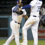 Los Angeles Dodgers right fielder Yasiel Puig, left, and first baseman Cody Bellinger celebrate after their win against the Arizona Diamondbacks in Game 2 of baseball's National League Division Series in Los Angeles, Saturday, Oct. 7, 2017. (AP Photo/Jae C. Hong)