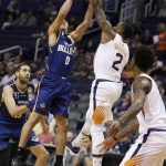 Phoenix Suns guard Eric Bledsoe (2) blocks the shot of Brisbane Bullets guard Travis Trice (0) during the first half of an NBA exhibition basketball game Friday, Oct. 13, 2017, in Phoenix. (AP Photo/Ralph Freso)