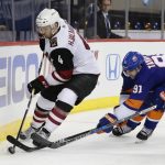 New York Islanders' John Tavares (91) fights for control of the puck with Arizona Coyotes' Niklas Hjalmarsson (4) during the second period of an NHL hockey game Tuesday, Oct. 24, 2017, in New York. (AP Photo/Frank Franklin II)