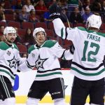 Dallas Stars center Radek Faksa (12) celebrates his goal against the Arizona Coyotes with Stars center Devin Shore (17) and Stars center Tyler Pitlick, middle, during the first period of an NHL hockey game Thursday, Oct. 19, 2017, in Glendale, Ariz. (AP Photo/Ross D. Franklin)