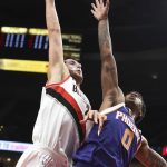 Portland Trail Blazers center Jusuf Nurkic goes up for a dunk over Phoenix Suns forward Marquese Chriss during the first half of an NBA basketball preseason game in Portland, Ore., Tuesday, Oct. 3, 2017. (AP Photo/Steve Dykes)